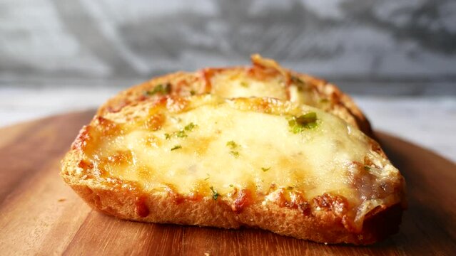close up of garlic bread on a chopping board 