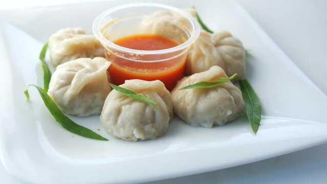 close up of chicken momo dumpling on a plate 