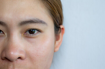 Close up of young Asian woman half face while looking to camera. The natural beauty of Asian woman...