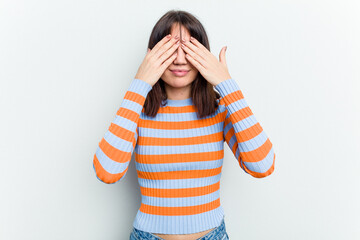 Young caucasian woman isolated on white background afraid covering eyes with hands.