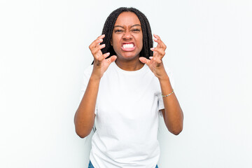 Young African American woman isolated on white background upset screaming with tense hands.