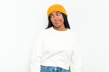 Young African American woman isolated on white background shrugs shoulders and open eyes confused.
