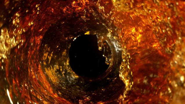 Super Slow Motion Shot of Golden Liquid Whirl Isolated on Black Background at 1000fps.