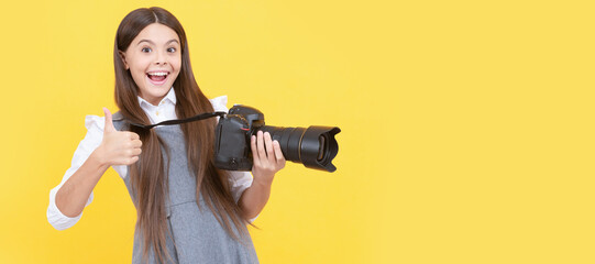 happy teen girl photographer use digital photo camera show thumb up, photographing. Child photographer with camera, horizontal poster, banner with copy space.