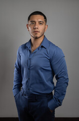 wearing a blue shirt a latin young man with short hair, business person in studio, lifestyle and fashion in studio