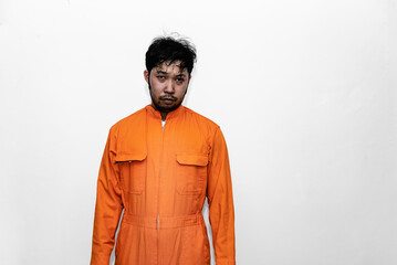 Prisoner in orange robe concept,Portrait of asian handsome man in Prison uniforms,Bandit has a lot...