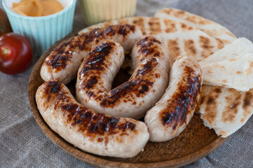 Grilled sausages with sauce and vegetables. Summer rest concept
