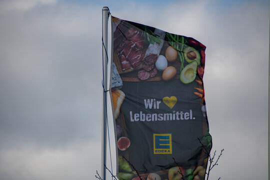 Greetsiel, Germany  12 March 2021,  EDEKA flag with its slogan "We love food"
