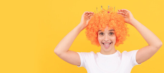 happy egoistic funny girl with fancy look wearing orange hair wig and princess crown, winner. Woman...