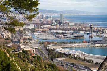 Fototapeta premium View of Barcelona city and sea shore with mountains on background. Vacation and travel concept