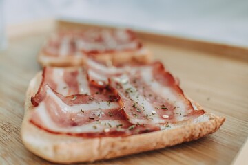 Easy and simple breakfast set of Bacon Sandwich served with black coffee on bed.