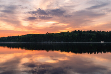 Beautiful sky reflected in a calm lake at sunrise.