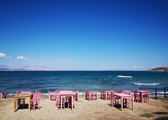 Fototapeta na wymiar pink chairs and tables on the beach