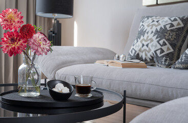 Modern living room interior. coffee table with flowers,sofa. Cozy home lounge.