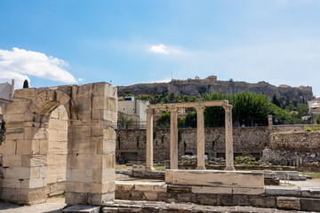 Scenic view of the columns and gate of ruined Library of Hadrian in Athens, Attica, Greece, Europe. Corinthian columns of the propylon of Pentelic marble. Ruins of ancient agora, birthplace democracy