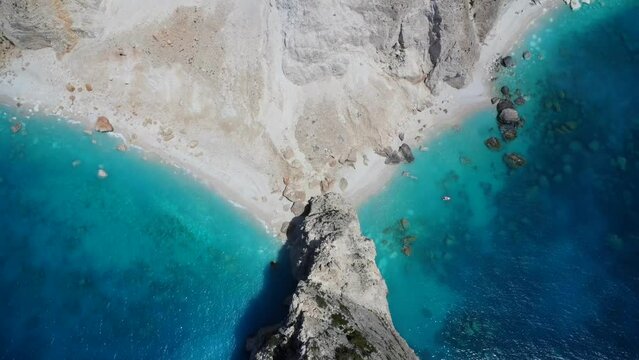 Aerial drone video of idyllic turquoise clear blue water with white sands and green flora near popular Keri cliffs, island of Zakynthos, Ionian, Greece