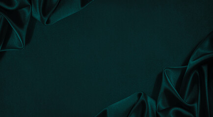 Dark blue green silk satin background. Beautiful soft folds. Smooth surface of the fabric. Luxury...