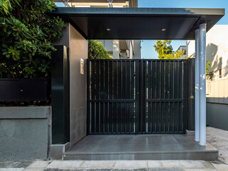 Contemporary house entrance metallic door. Tranquil Athens suburbs, Greece.
