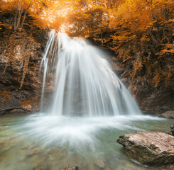 Fototapeta na wymiar Spring waterfall flow.