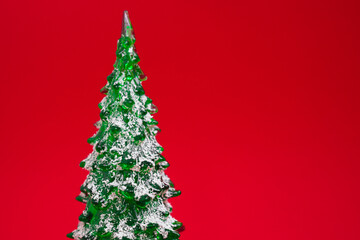 Green Christmas toy Tree isolated on red background
