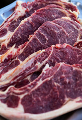 Portuguese uncooked Beef Steaks, top view vertical image, Portugal.