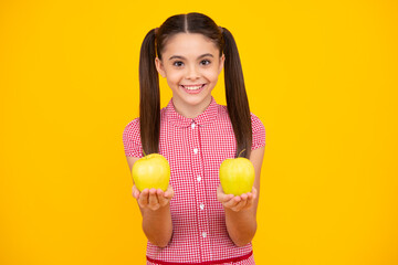 Fresh fruit. Teenager girl hold apples on yellow isolated studio background. Child nutrition. Happy teenager, positive and smiling emotions of teen girl.