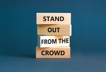 Stand out from the crowd symbol. Concept words Stand out from the crowd on wooden blocks on...