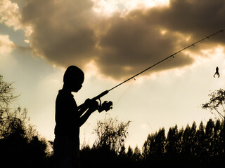 silhouette of a child fishing children s happy time in the