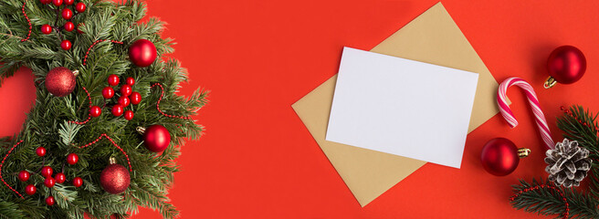 Christmas banner. Christmas wreath and greeting card for text on the red background. Copy space.