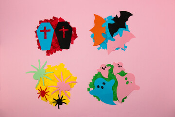 4 piles of paper of different colors on each different halloween monster, creative art design, flat lay, paper craft
