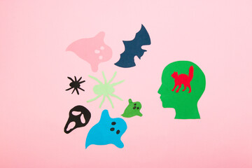 paper head with the brain of a scared little cat, the man got scared halloween monters, flat lay, paper craft, creative idea
