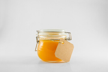 Orange jam in glass jar with label