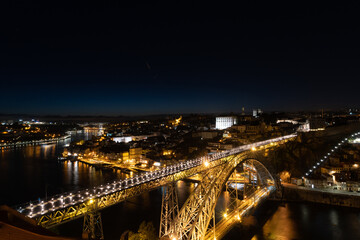 Don Luis I Bridge, in Porto, at night, with the entire city of Porto illuminated