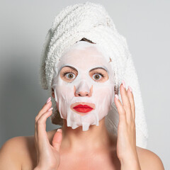 Portrait of a woman with a cotton mask to moisturize her face.