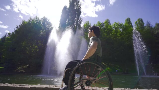A highly motivated young man in a wheelchair.
Physically handicapped teenager sitting outside in a wheelchair.
