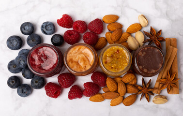 Jar of honey. Fruit honey with raspberries, blueberries, almonds and pistachios. Jams for health and beauty. Honey cream. Organic product of a vegetarian diet. Copy space.Copy space.
