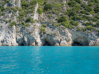 Fototapeta premium Beautiful beach with stone caves in Greece