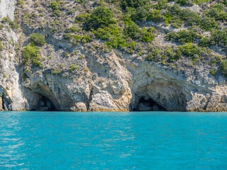 Fototapeta premium Beautiful beach with stone caves in Greece