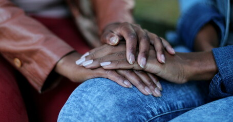 Close-up hands consoling and caring, African black ethnicity