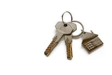 Keys with a keychain in the form of a house are isolated on a white background. The concept of buying, renting, home insurance. Real estate transactions.