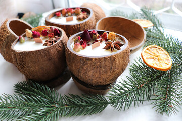 original christmas candle in coconut and fir branches	
