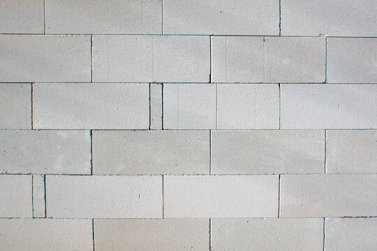 Gas silicate wall from white porous blocks for a background texture