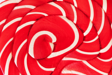 Red colored caramel lollipops texture. Sweet candy close-up.