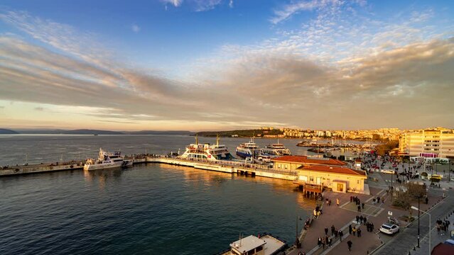 Aerial day to night sunset timepase of Canakkale ferry pier, Turkey. Ferry across the Dardanelles