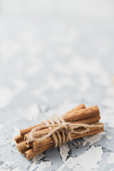 Christmas still life on the windowsill. Concrete background, gifts, candles and garlands