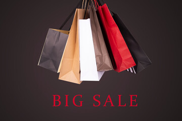 Big Sale banner with shopping bags on a black background