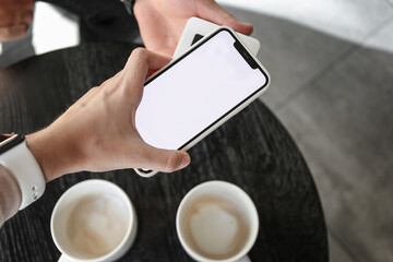 Obraz premium payment in a restaurant or cafe using a smartphone and a mobile terminal
