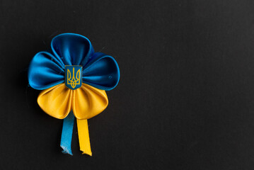 Ukrainian flag flower from ribbons on a black matte background
