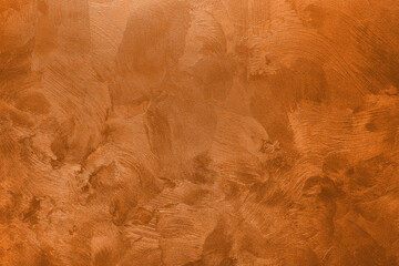 Abstract background of textured wall of orange color.