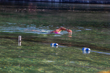Swimmer strokes on a Florida natural spring pool 